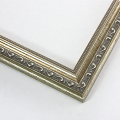 This thin elegant frame is made out of wood with an antique silver finish. It features a distressed border on the inner and outer edge of the profile. As well as displays intricate designs and beading to illuminate its traditional vintage appeal.